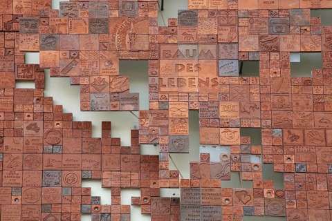 Art installation Tree of Life made of many small different tiles, various red monochrome tiles,