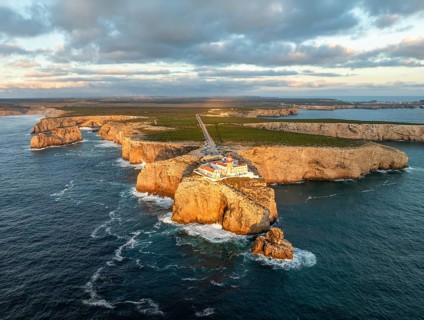Drone view of the Lighthouse of Cabo de Sao Vicente in Sagres, Algarve, Portugal, at sunset with