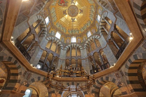 Interior view of octagon with seating and chandelier, vaulted ceiling, handicrafts, ornaments, wall