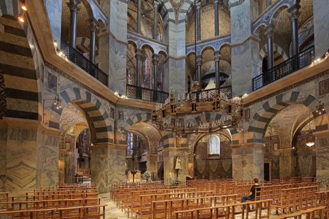 Interior view of octagon with seating and chandelier, handicrafts, ornaments, wall mosaic,