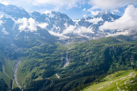 Schmadribachfall waterfall and picturesque mountain landscape with Breithorn mountain peak, Bernese