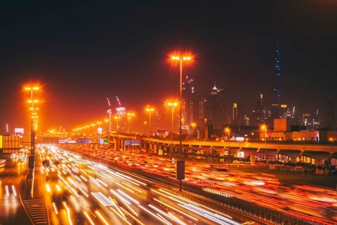 Panorama Dubai heavy night night traffic on Sheikh Zayed Road after work rush hour traffic. Light