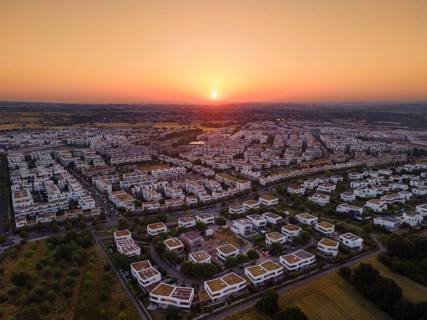 The sun rises behind the houses in Frankfurt's Riedberg district, Germany