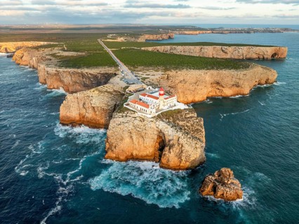Drone view of the Lighthouse of Cabo de Sao Vicente in Sagres, Algarve, Portugal, at sunset with