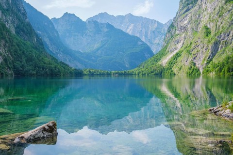 Obersee mountain lake Alps Bavaria Germany in wide view with turquoise water, green trees, rocky