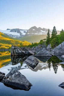 Picturesque mountain landscape in the Innerdalen high valley, mountain peaks are reflected in Lake