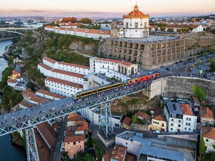 Drone view of Dom Luis I Bridge over Douro River in Porto, Portugal, with the river bend, including