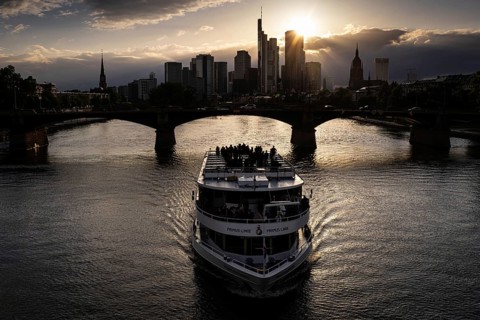The sun sets behind Frankfurt's banking skyline, Frankfurt am Main, Hesse, Germany