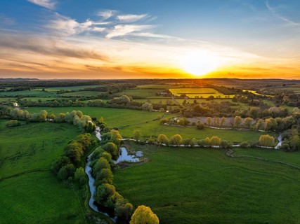 Sunset of Fields and Farms over Horsebridge nad Stockbridge from a drone, Hampshire, England,