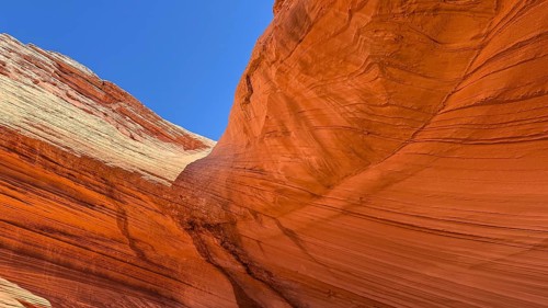Antelope canyon displaying flowing sandstone rock formations with vibrant colors and contrasting