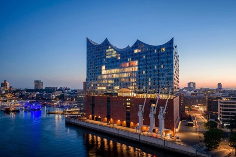 Aerial view of sunrise on the Elbe with Elbe Philharmonic Hall and reflections in the glass façade,