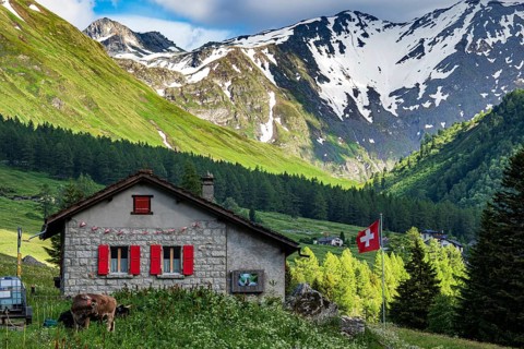 Upper end of valley Val Ferret, traditional stone house, swiss flag, Val de Ferret, Valais,