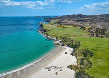 Aerial photo of a bay with golden sand beach at the scottish atlantic coast near Coldbackie,