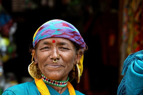Portrait, friendly smiling elderly Nepalese woman with traditional jewelry and bindi, Hindu ethnic