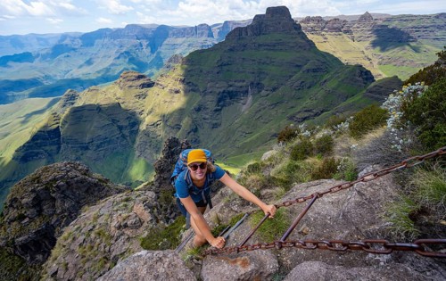 Steep ladder, female mountaineer on the hiking trail to Cathedral Peak or Cathedralpiek or