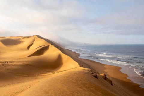 Sand dunes and sea, Atlantic coast and sandy desert with sea of dunes, Sandwich Harbour, Namib