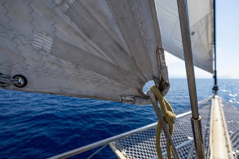 Close-up of a sail and dew with a view of calm, blue sea, Aeolian or Lipari islands, Sicily,