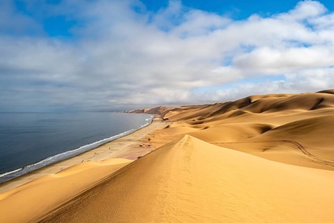 Sand dunes and sea, Atlantic coast and sandy desert with sea of dunes, Sandwich Harbour, Namib