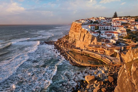 Azenhas do Mar with its stunning seaside charm as sunlight casts warm tones over the cliffs and