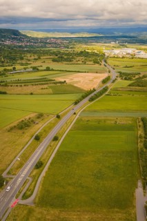 Extensive landscape with roads and fields surrounded by hills under a cloudy sky, Herrenberg,