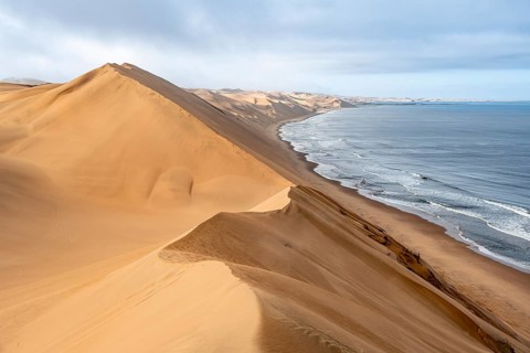 Sand dunes and sea in the morning, Atlantic coast and sandy desert with sea of dunes, Sandwich