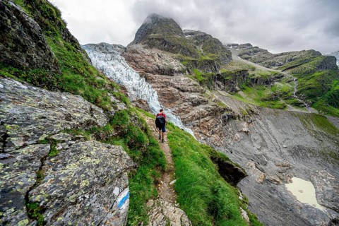 Mountaineers on a hiking trail, dramatic mountain landscape with Lower Arctic Sea glacier, Bernese