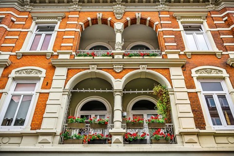 Balconies with flower boxes of a residential and commercial building in the Sachsentor in