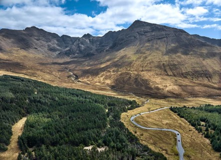 Aerial panoramic drone photo landscape of the Black Cuillins mountain chain with the tourist