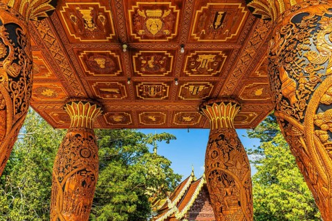 Decorated wooden ceiling of a pagoda supported by filigree carving columns, Wat Phra That Doi