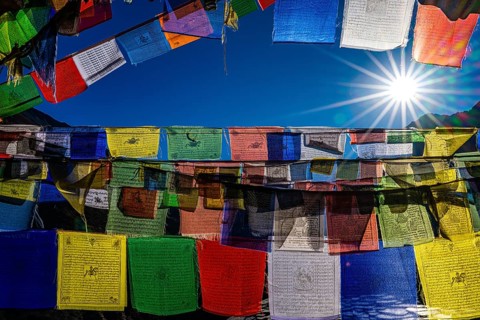 Tibetan Buddhist prayer flags printed with sacred mantras in sunlight, Tsum Valley, Mu Gompa,