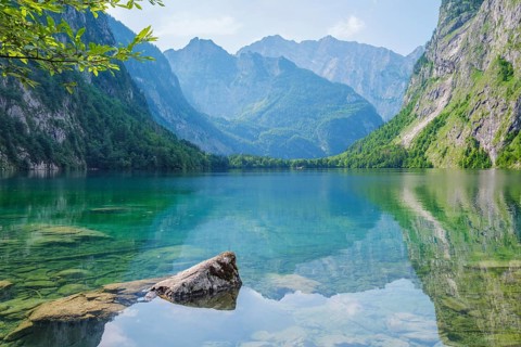 Obersee mountain lake Alps Bavaria Germany with submerged rocks in transparent water, mirrored