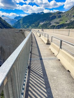Footpath and roadway for company vehicles on a 200-meter high Kölnbrein dam left airside facing