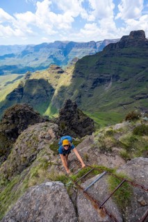 Steep ladder, female mountaineer on the hiking trail to Cathedral Peak or Cathedralpiek or