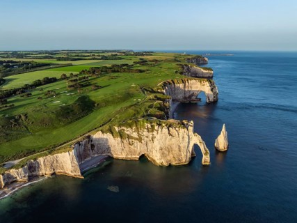 Aerial view of the Porte d'Aval rock formation with the free-standing Aiguille d'Étretat rock pin