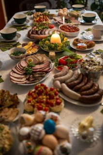 Traditional Easter festive table setting with eggs, zurek soup, and various dishes for a holiday