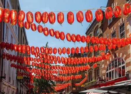 Red Chinese lanterns suspended over street in Chinatown, Gerard Street, Soho, London, England, UK