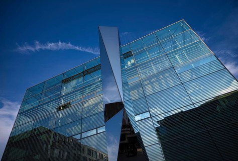 Glass and polylite sculpture by Carsten Nicola in front of the art museum, cube, glass cube,