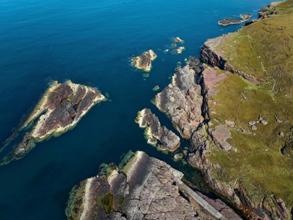 Aerial photo of the red cliffs at Rua Reidh Point, Gairloch, Scotland, UK
