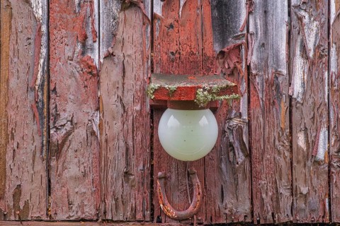 View of a lamp in a barn on a farm in the mountains of Gol in the rain, Halligdal, Buskerud, Norway