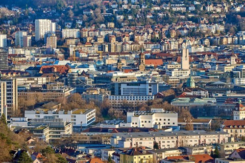 Panoramic view of Stuttgart city center in Germany during spring with warm golden evening light.