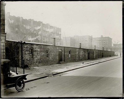 New York, Harlem, poverty, black residents, USA, deserted street with old brick houses in a foggy