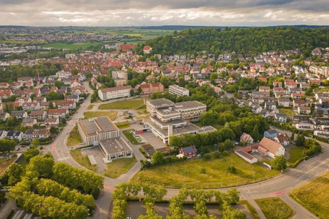 Aerial view of an urban landscape with a large building and numerous houses, new IGZ, The