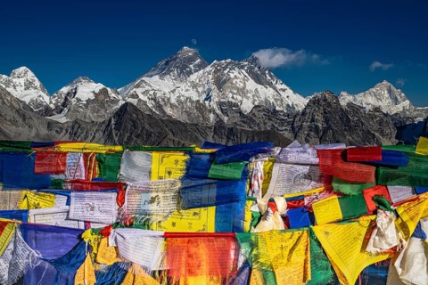 View from Renjo La Pass, 5360 m with Buddhist prayer flags with holy mantras with views of the