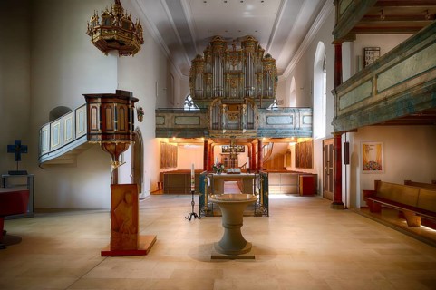 Interior view of Greek cross on altar, organ, pulpit, baptismal font, paintings of the Cross,