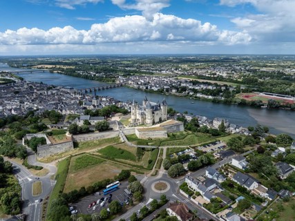 Aerial view of the historic Château de Saumur with its distinctive round corner towers and bright