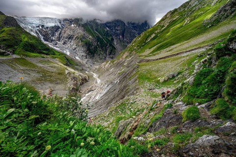 Dramatic mountain landscape covered in clouds with Grindelwald-Fiescherfirn glacier, Bernese Alps,