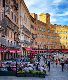 Tourists, sights and restaurants on the famous Piazza del Campo, Siena, Tuscany, Italy