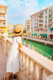 Doha, Qatar - 20th january, 2026: Woman traveler enjoy canal views in Qanat Quartier Pearl Qatar