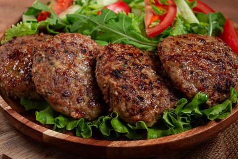 Fried cutlets, mixed minced meat, with vegetable salad, homemade, top view, no people