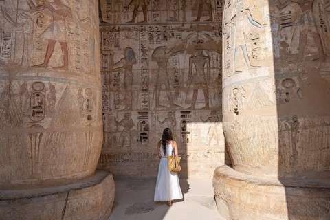 Luxor, Egypt. January 6th 2026. A foreign tourist admires reliefs and hieroglyphs inside Medinat